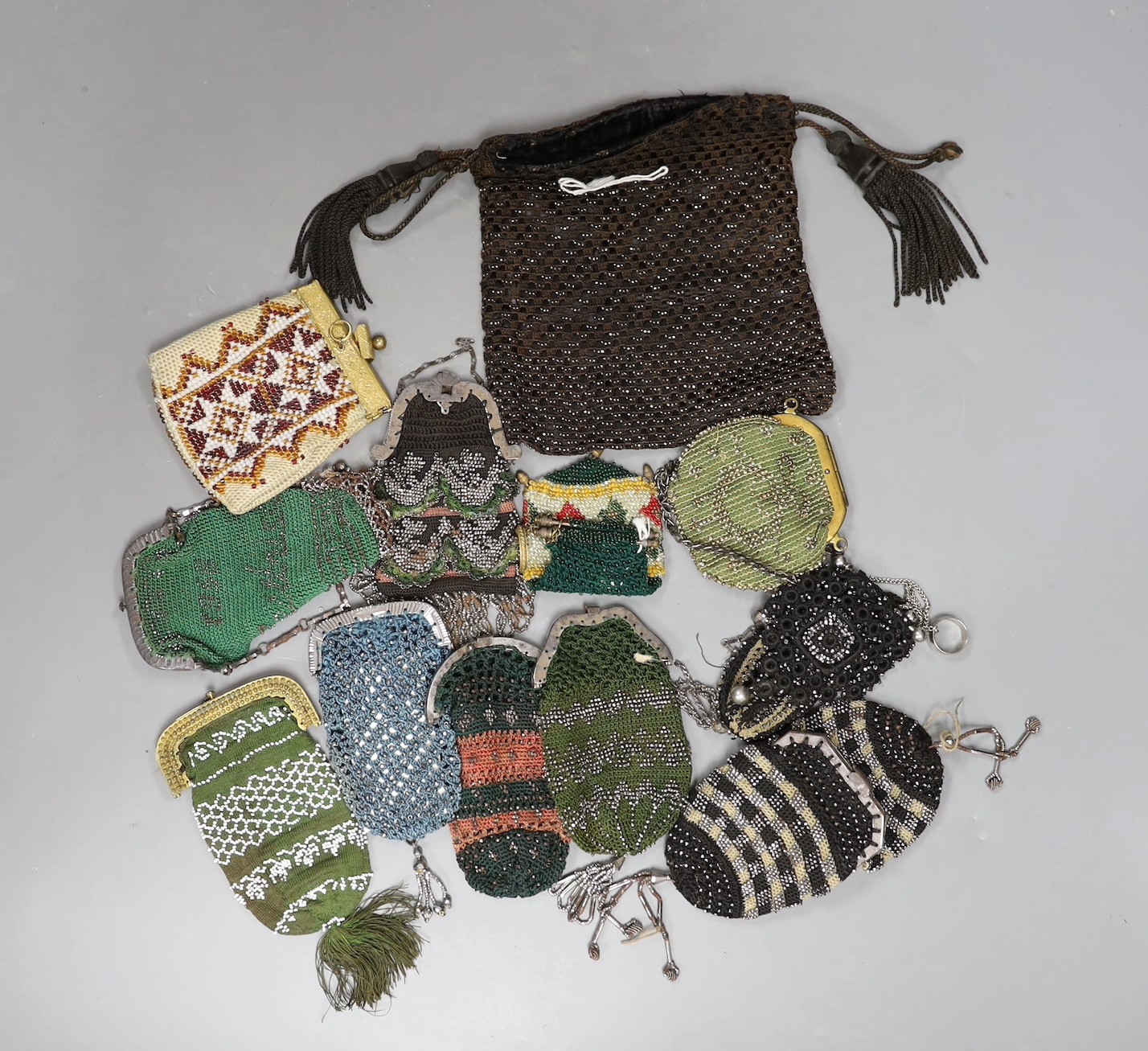 Nine wool and cut steel 19th century ladies coin purses, seven with metal frames and clasps, two with open bar tops, a similar bible bag with tassels and three bead work purses